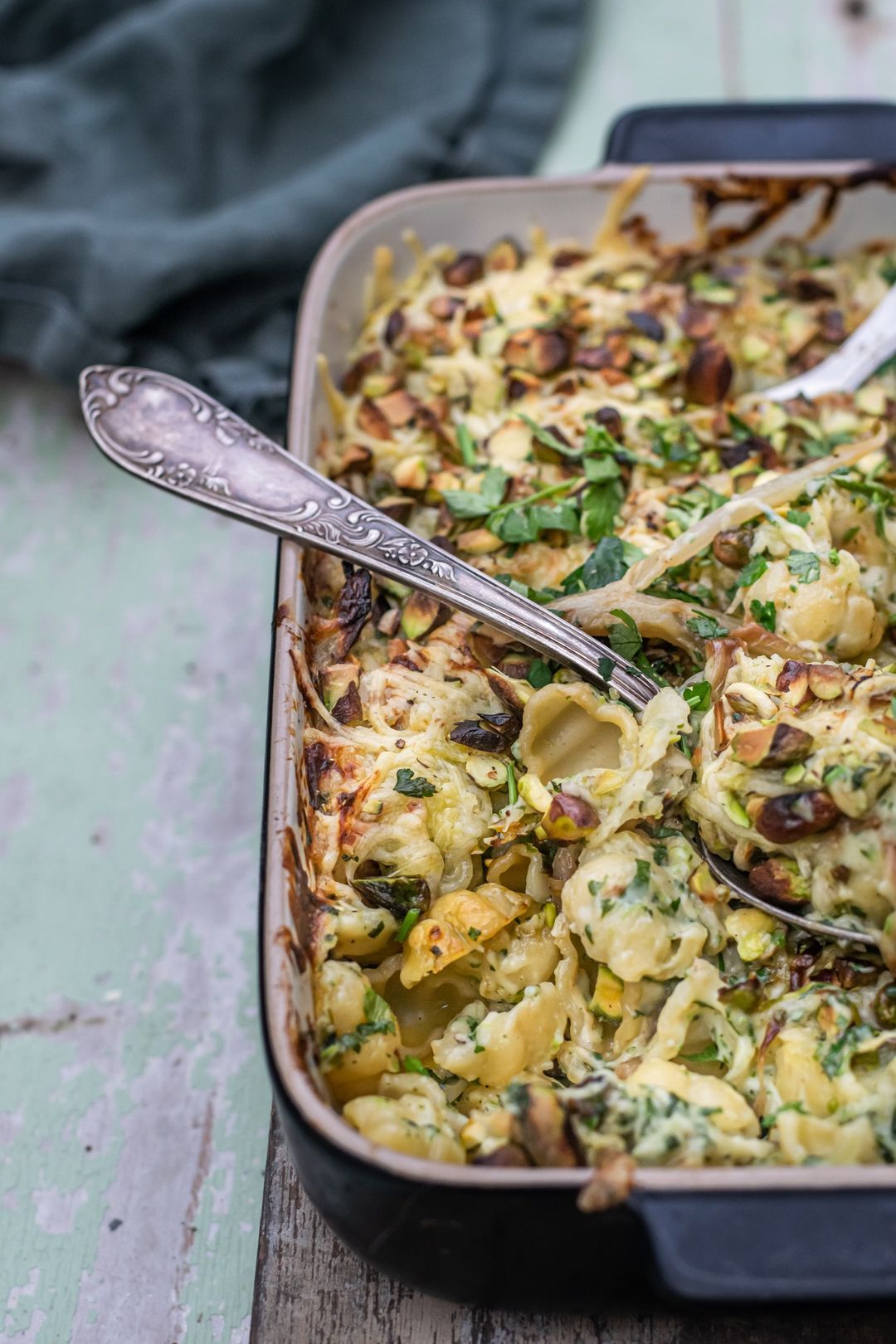 Pasta dish with pasta, chicory, cheese sauce and pistachio